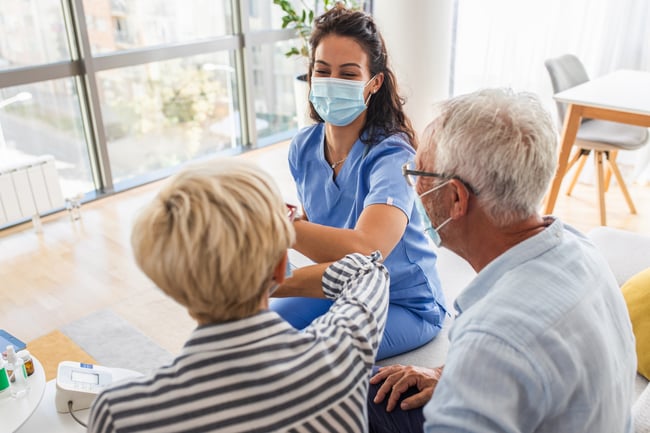 Caregiver with Mask giving elbow greeting