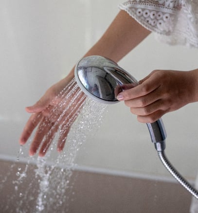 checking handheld shower water as part of senior personal care services
