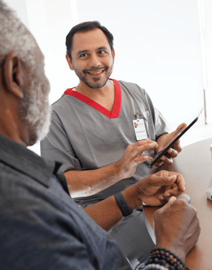 Male caregiver on a tablet with male client