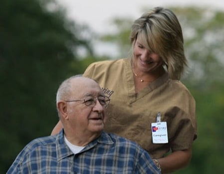 Caregiver with Elderly Man in Wheelchair