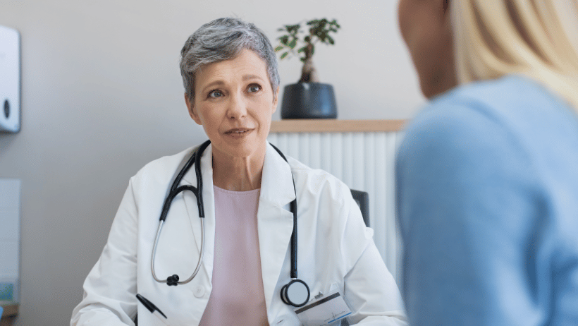 Adult child talking with a doctor at the hospital